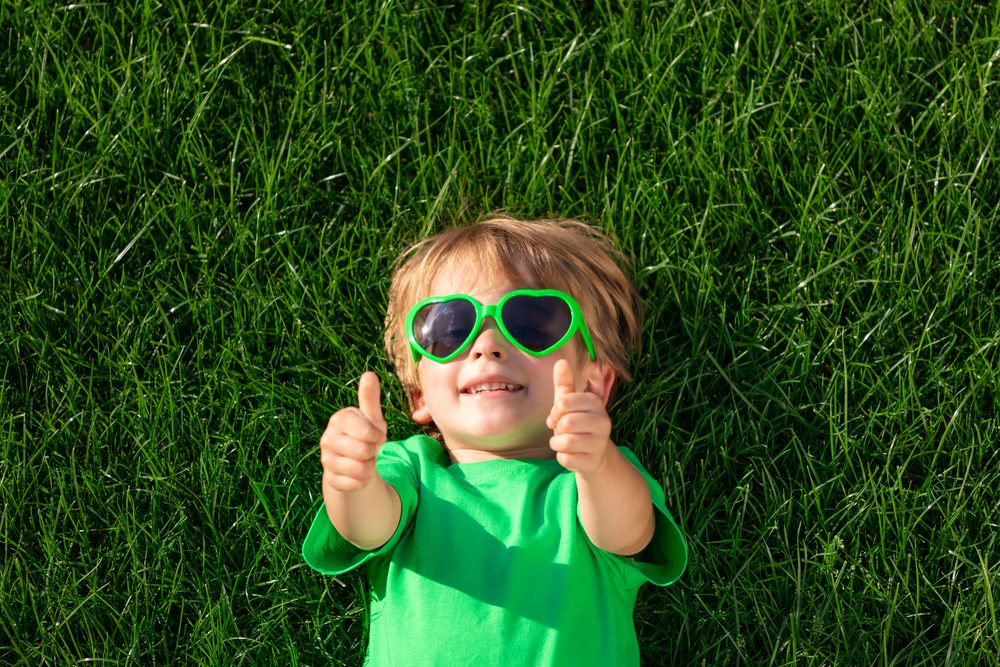 Happy,Child,Laying,On,Green,Grass.,Funny,Kid,Outdoor,In